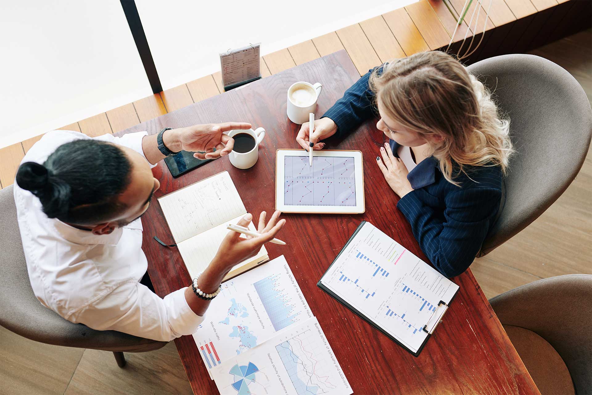 business-people-analyzing-reports-2023-11-27-05-13-41-utc.jpg